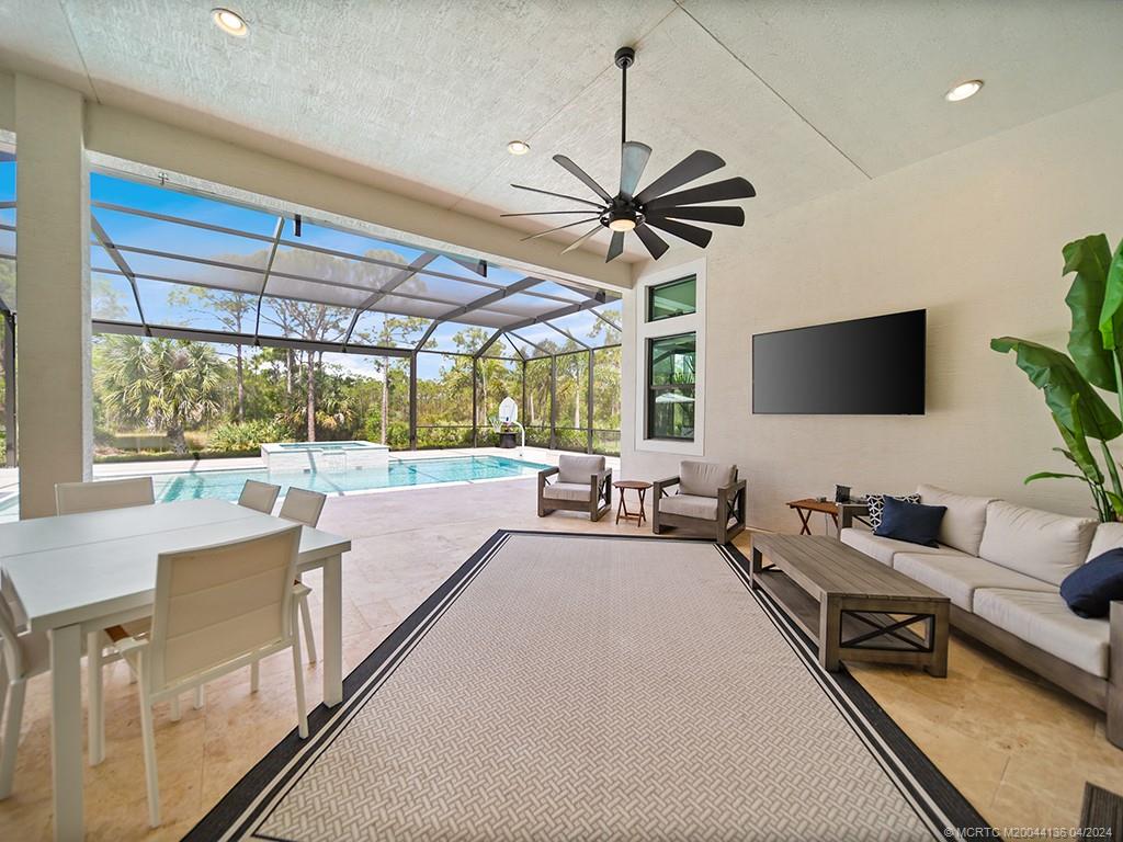 3246 Southwest Loriope Loop Palm City, FL 34990 - Photo 26 of 37 a living room with furniture and a flat screen tv