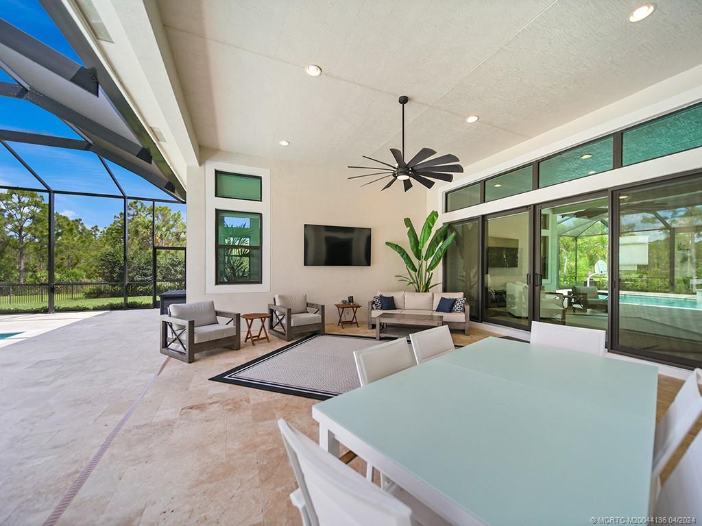 3246 Southwest Loriope Loop Palm City, FL 34990 - Photo 27 of 37 a living room with furniture and large windows