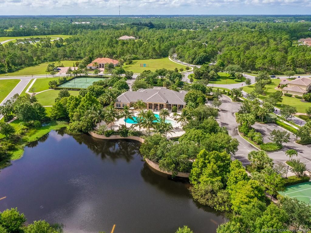 3246 Southwest Loriope Loop Palm City, FL 34990 - Photo 33 of 37 a view of a lake with a house in the background