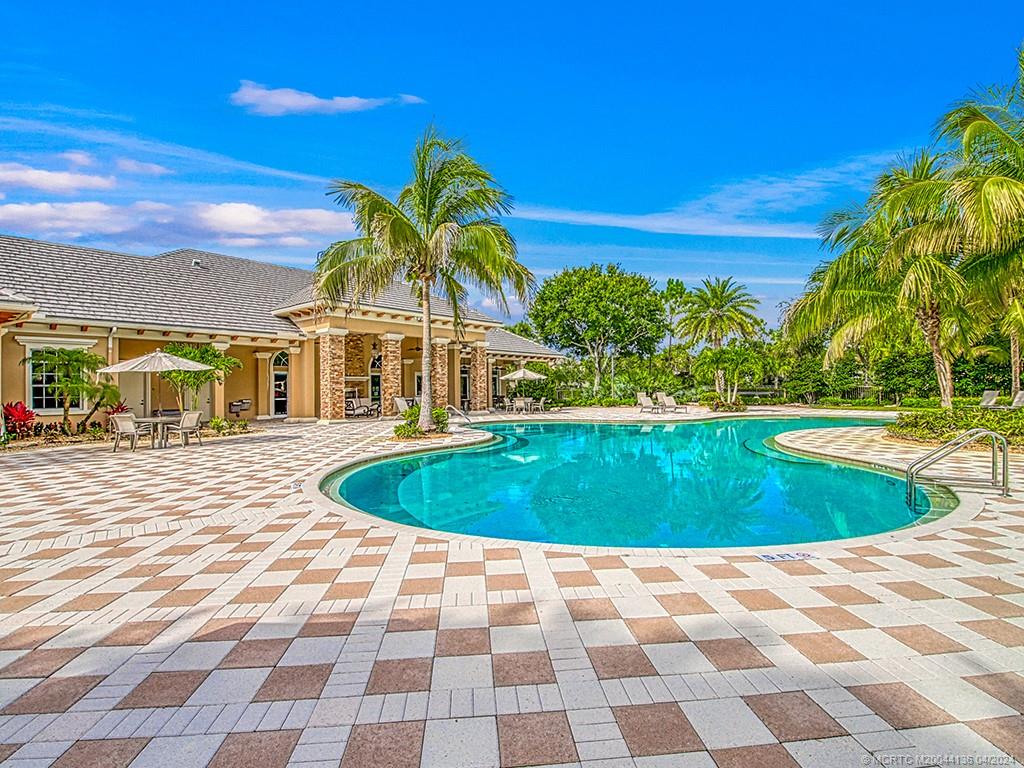 3246 Southwest Loriope Loop Palm City, FL 34990 - Photo 34 of 37 a swimming pool with outdoor seating and yard