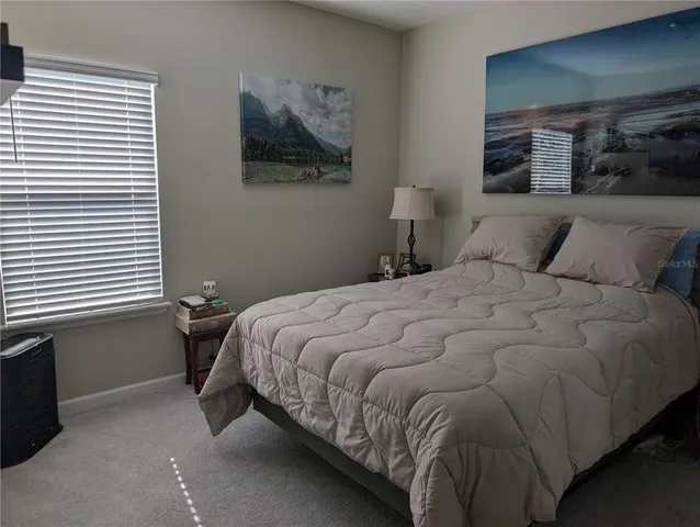 a bedroom with a bed and wall painting
