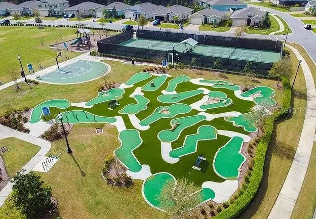 a swimming pool with outdoor seating and yard