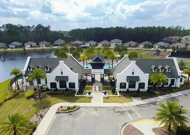 a view of house with swimming pool and mountains in the background