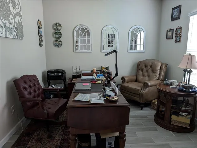 a living room with furniture a rug and a window
