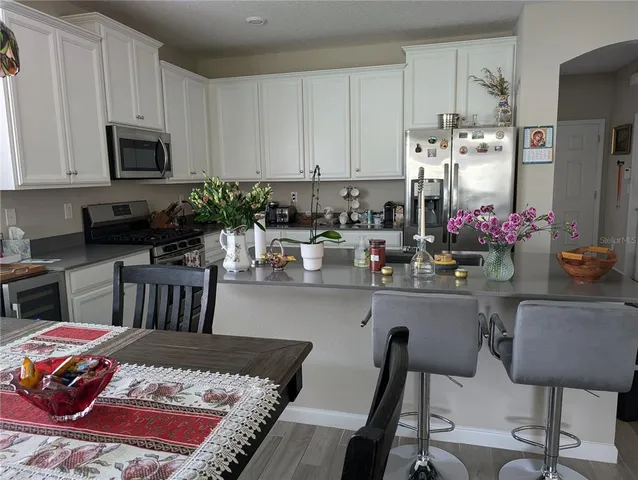 a kitchen with stainless steel appliances granite countertop a sink stove and cabinets