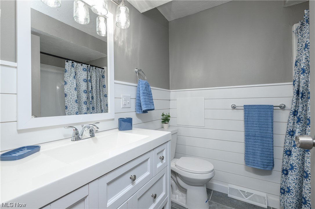 279 South Messner Road New Franklin, OH 44319 - Photo 11 of 30 Bathroom with tile flooring, toilet, and vanity with extensive cabinet space