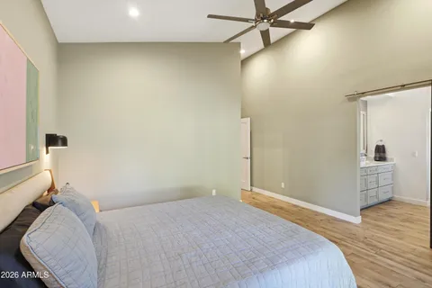 a bedroom with a bed and a chandelier
