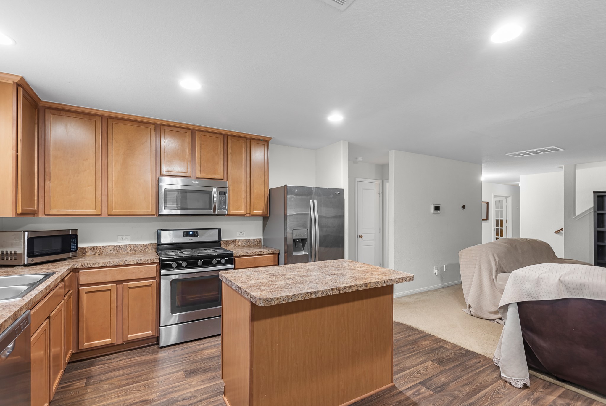 1614 Perennial Lane Rosenberg, TX 77471 - Photo 12 of 34 a kitchen with stainless steel appliances granite countertop a stove top oven a sink dishwasher a refrigerator and cabinets with wooden floor