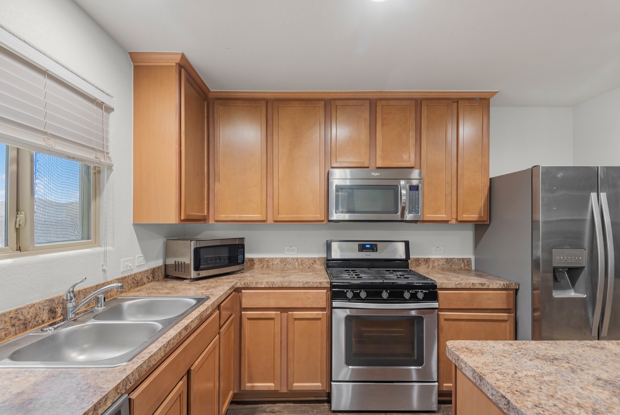 1614 Perennial Lane Rosenberg, TX 77471 - Photo 15 of 34 a kitchen with a sink stove and refrigerator