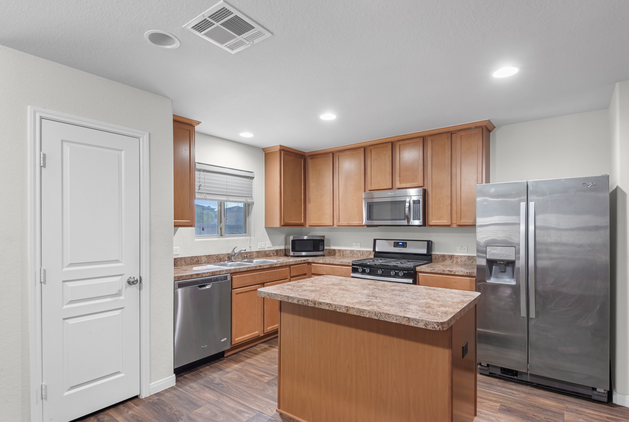 1614 Perennial Lane Rosenberg, TX 77471 - Photo 16 of 34 a kitchen with a sink a counter top space stainless steel appliances and cabinets