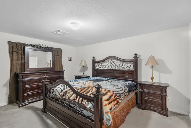 a bedroom with a bed and dresser