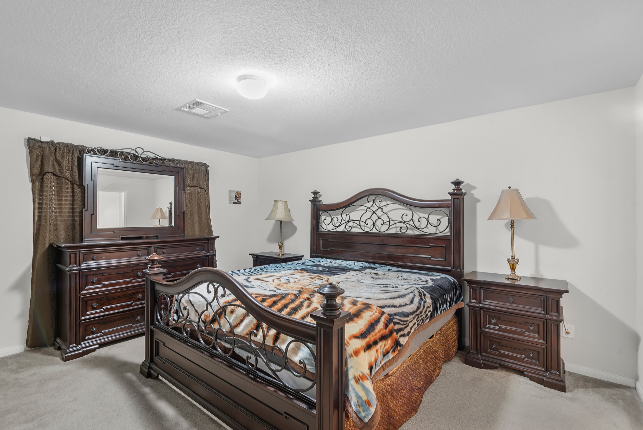 1614 Perennial Lane Rosenberg, TX 77471 - Photo 19 of 34 a bedroom with a bed and dresser