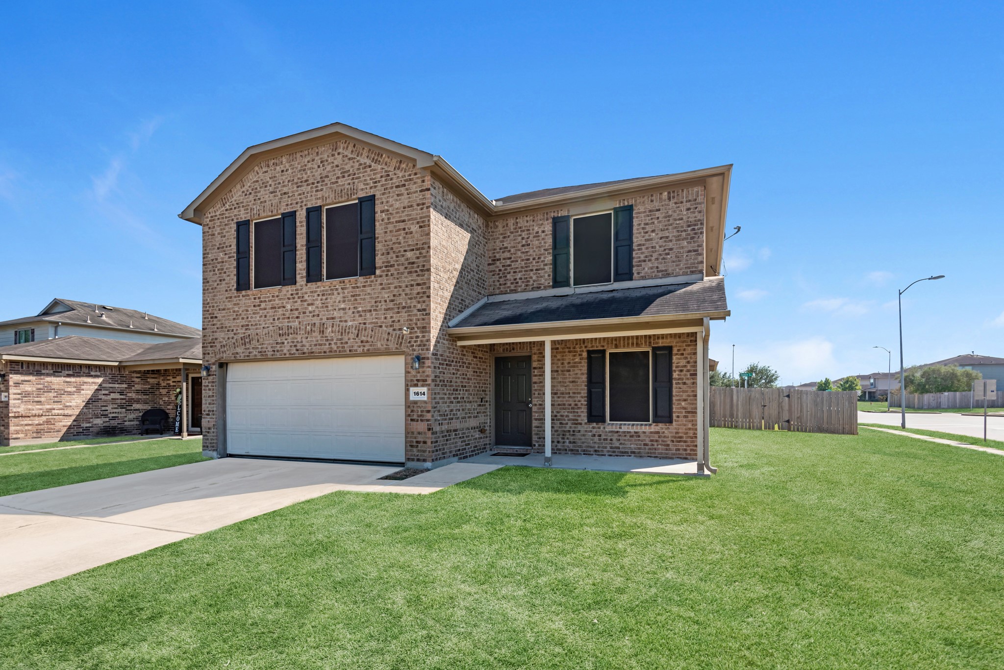 1614 Perennial Lane Rosenberg, TX 77471 - Photo 2 of 34 a front view of a house with a garden and yard