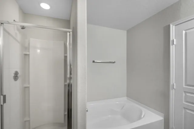 a bathroom with a tub and shower