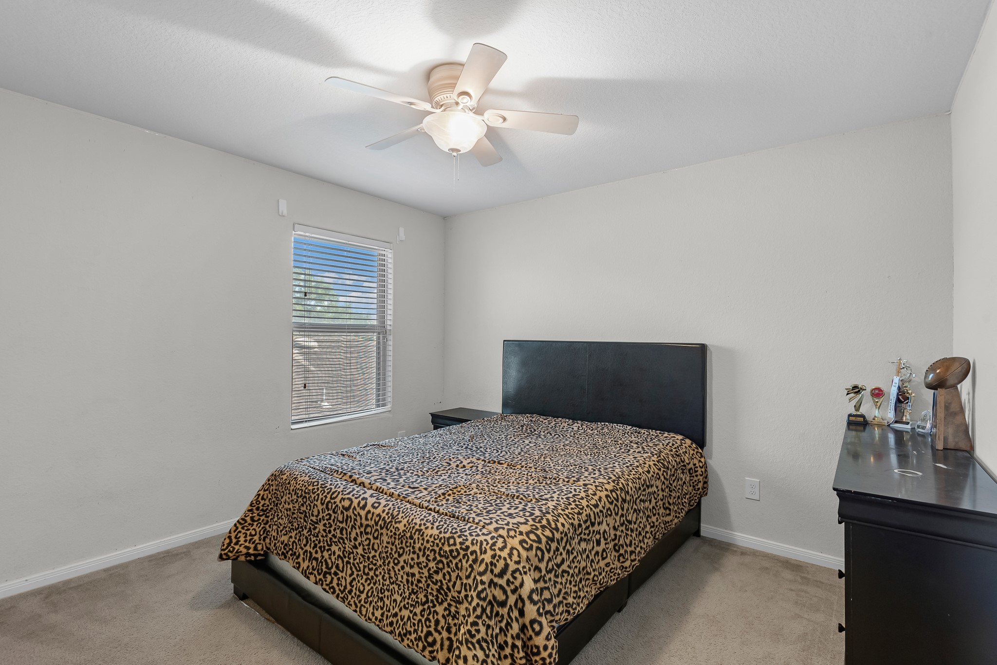 1614 Perennial Lane Rosenberg, TX 77471 - Photo 28 of 34 a bedroom with a bed and a chandelier