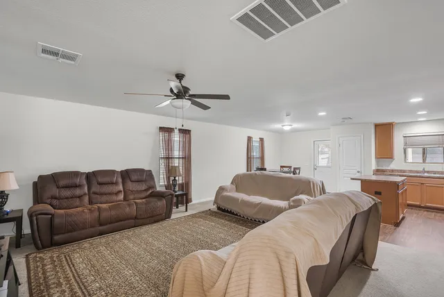 a living room with furniture ceiling fan and a couch