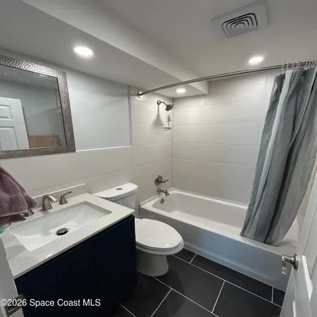 a bathroom with a sink toilet tub and shower