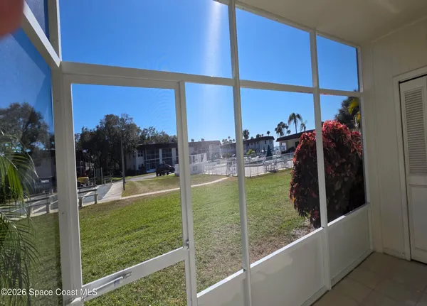 a view of a living room and floor to ceiling window