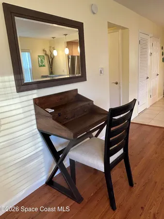 a living room with a table and paintings on the wall