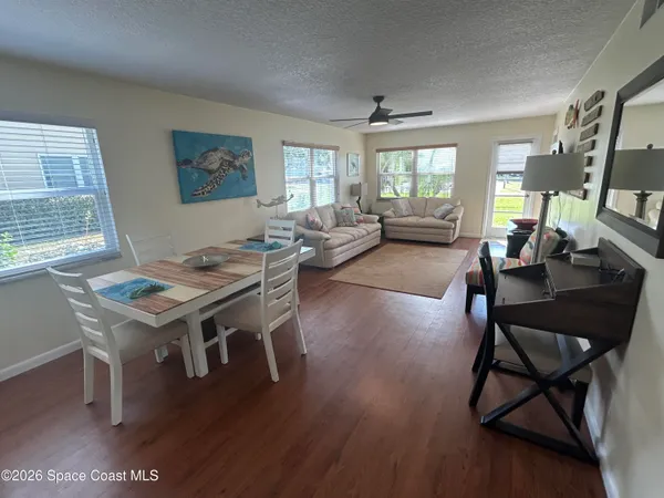 a living room with furniture a window and a table