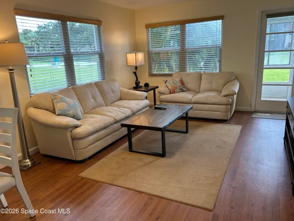 a living room with furniture and a large window