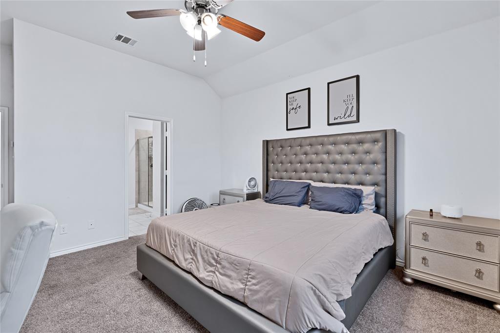 717 Rawhide Way Princeton, TX 75407 - Photo 11 of 31 a bedroom with a bed and a chandelier