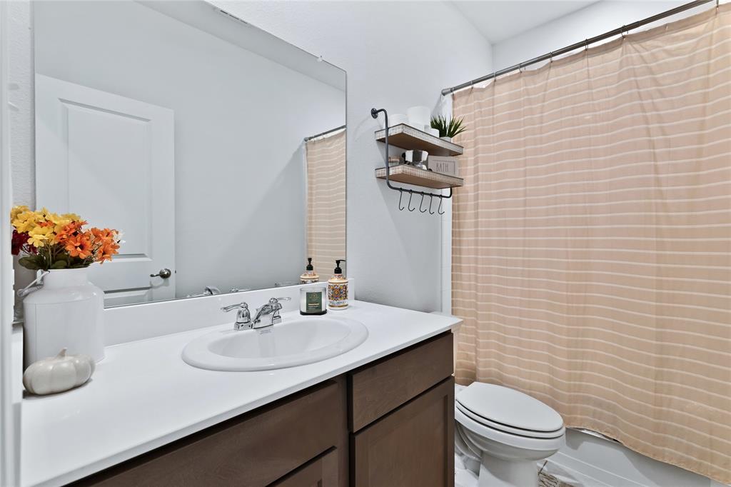 717 Rawhide Way Princeton, TX 75407 - Photo 14 of 31 a bathroom with a sink toilet and mirror