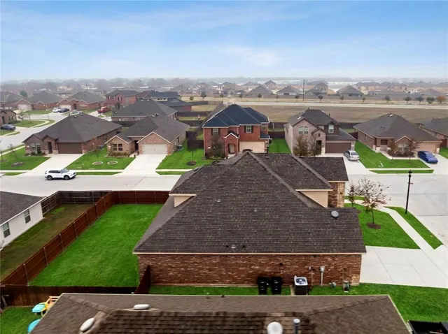 an aerial view of residential houses with outdoor space