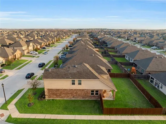 an aerial view of a house with a swimming pool