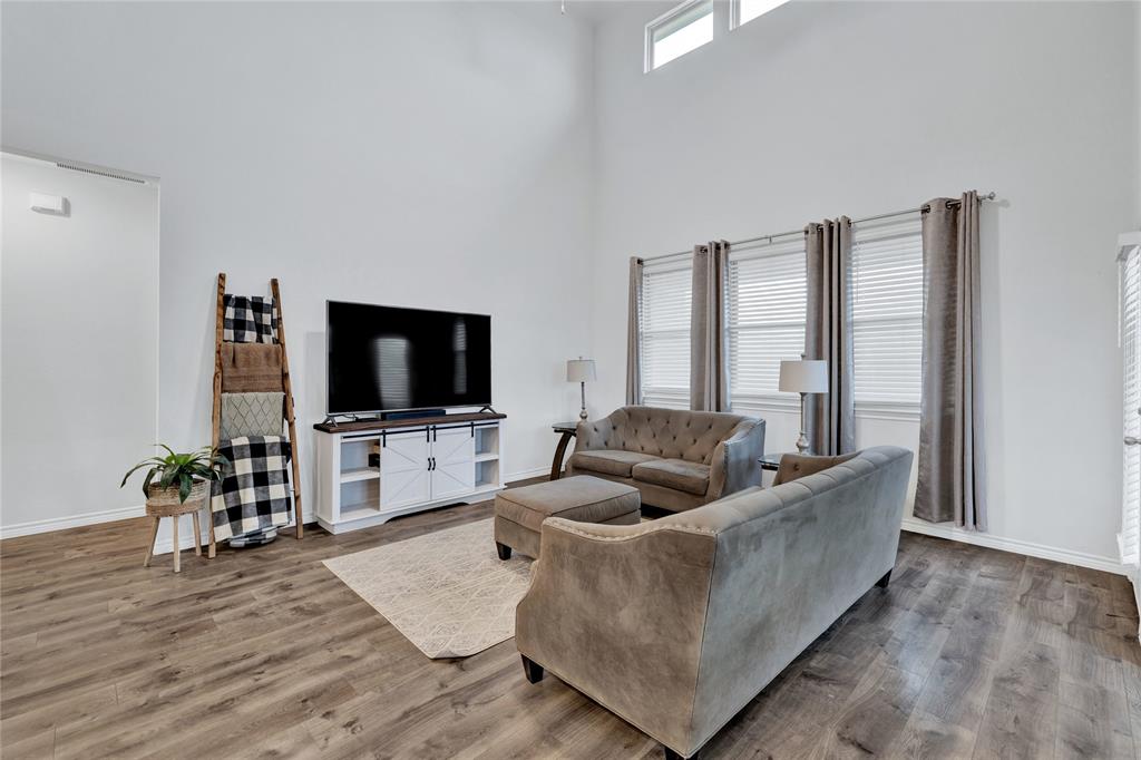 717 Rawhide Way Princeton, TX 75407 - Photo 4 of 31 a living room with furniture and a flat screen tv