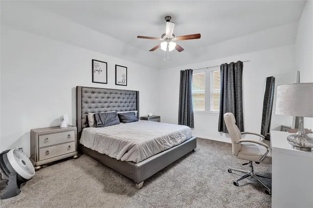 a kitchen with refrigerator and chairs