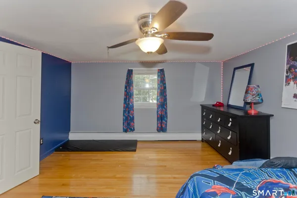 a bedroom with furniture and a flat screen tv