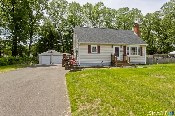 a front view of house with yard and green space