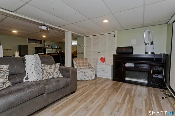 a kitchen with stainless steel appliances granite countertop a stove a sink dishwasher and a refrigerator with wooden floor