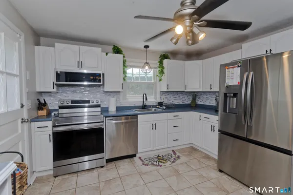 a kitchen with cabinets stainless steel appliances and a counter space