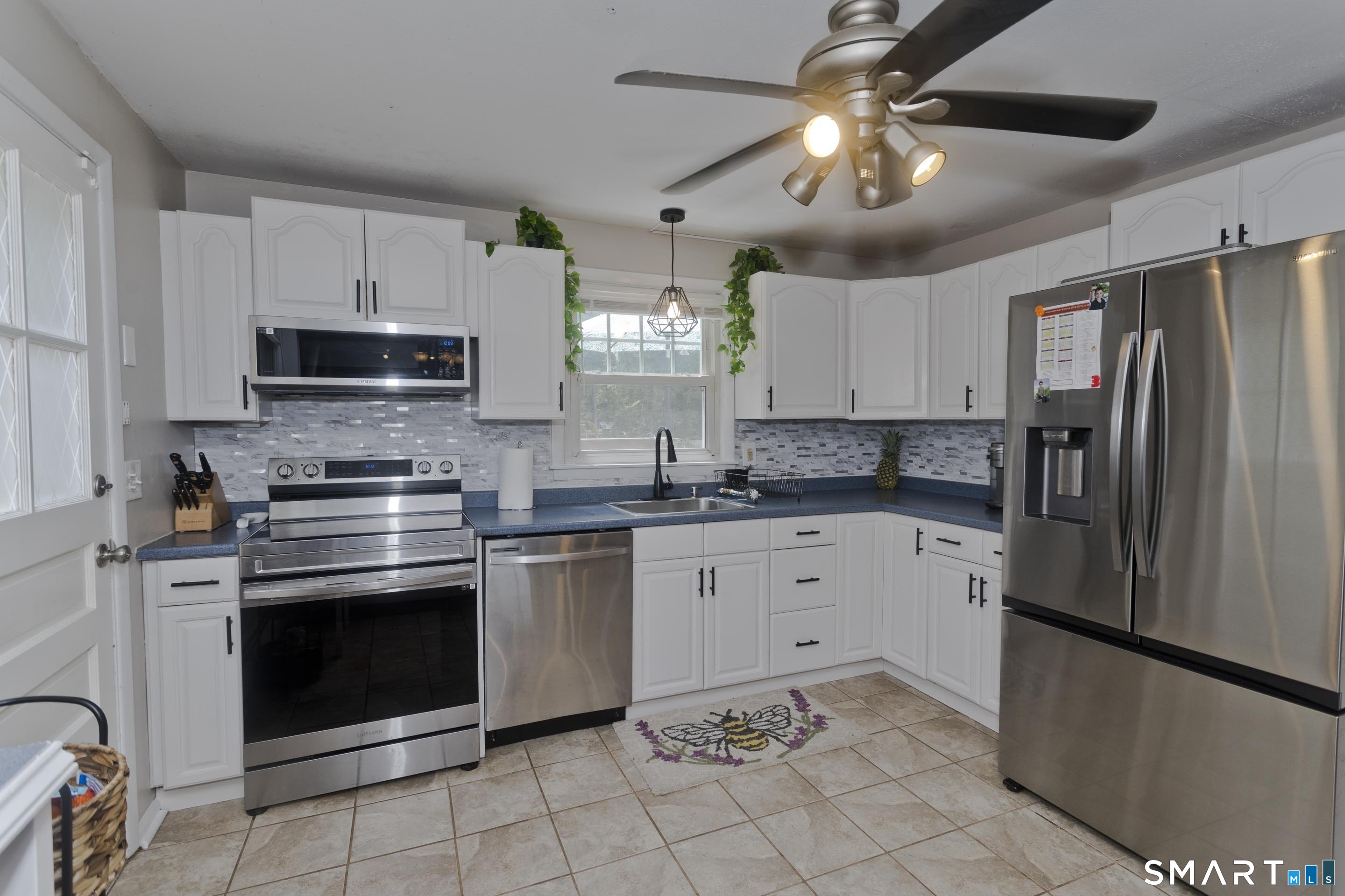 309 South Elm Street Windsor Locks, CT 06096 - Photo 4 of 38 a kitchen with cabinets stainless steel appliances and a counter space