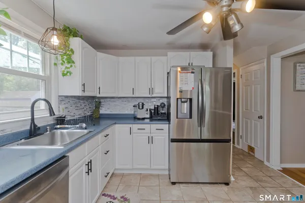 a kitchen with appliances a sink and cabinets
