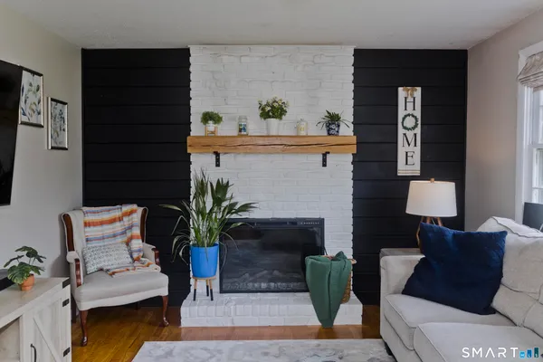 a living room with furniture and potted plant