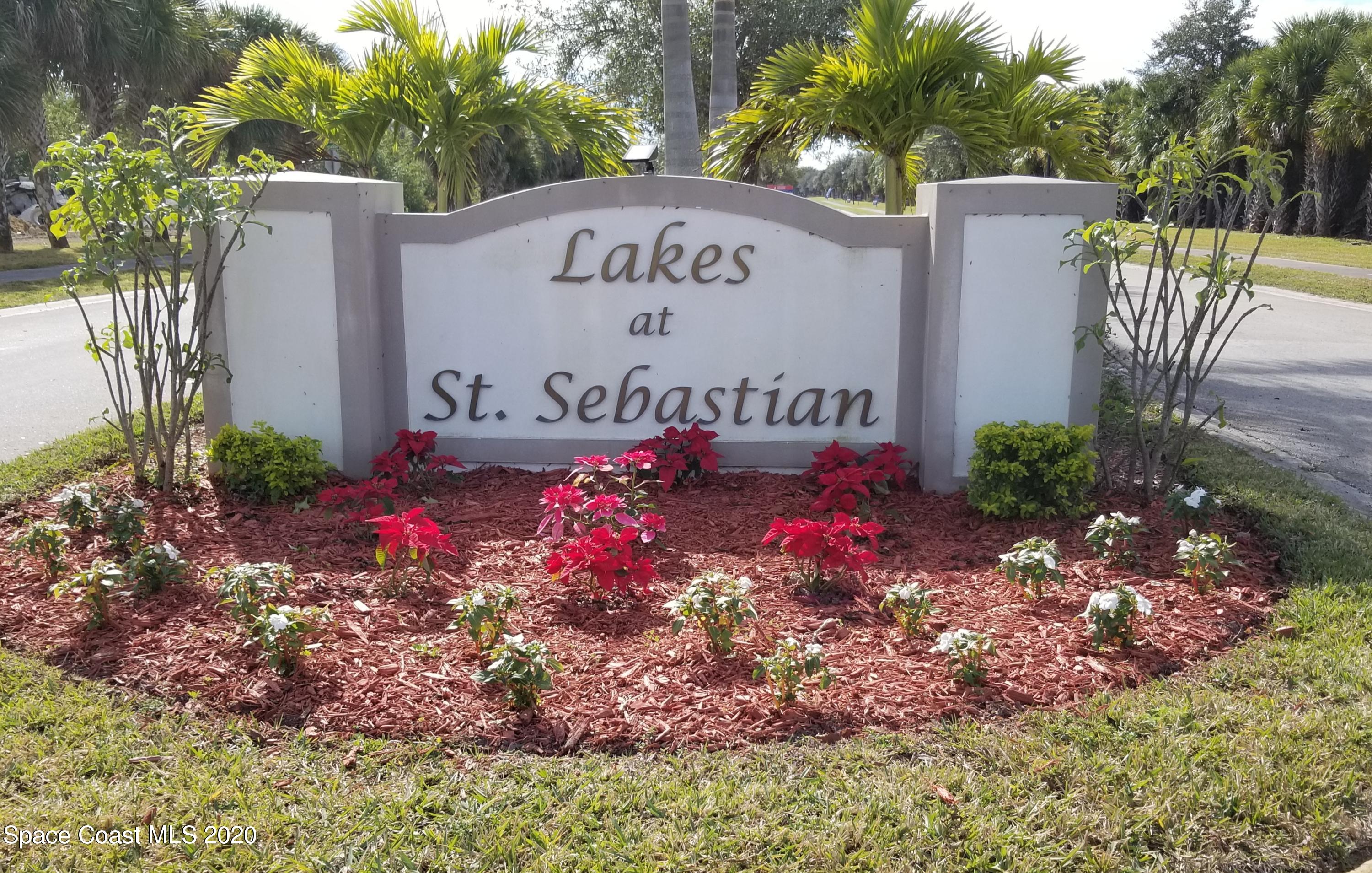 a sign that is in front of flowers