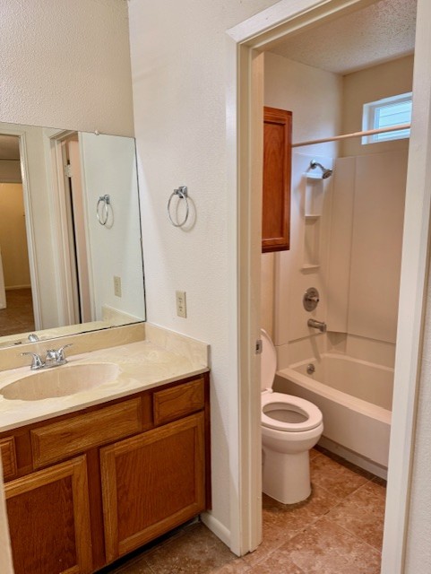 9006 B Sedgemoor Trail Austin, TX 78748 - Photo 14 of 16 Bathroom featuring bathtub / shower combination, vanity, a textured ceiling, and light tile patterned flooring