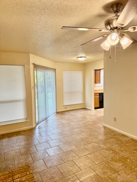 9006 B Sedgemoor Trail Austin, TX 78748 - Photo 5 of 16 Spare room featuring a textured ceiling and a ceiling fan