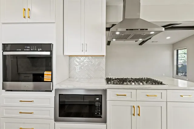 a kitchen with a stove and cabinets