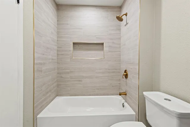 a bathroom with a bathtub and a toilet