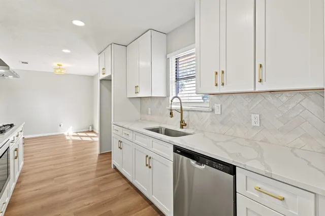 a kitchen with a sink and cabinets