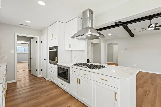 a kitchen with stainless steel appliances kitchen island a stove and a refrigerator