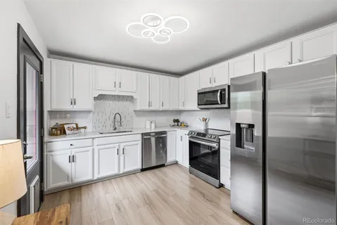 a kitchen with granite countertop stainless steel appliances and wooden cabinets