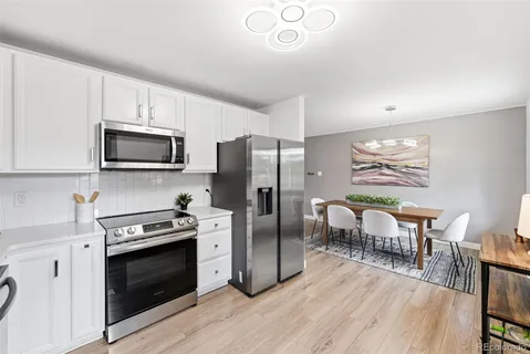 a kitchen with stainless steel appliances a stove microwave and refrigerator