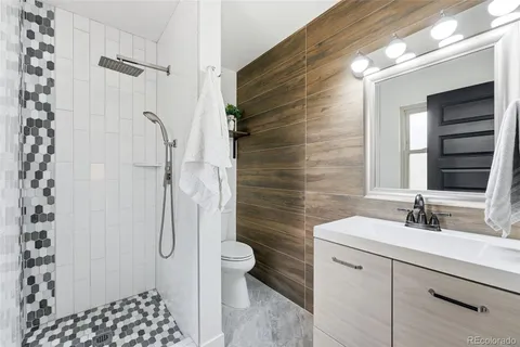 a bathroom with a sink toilet and shower