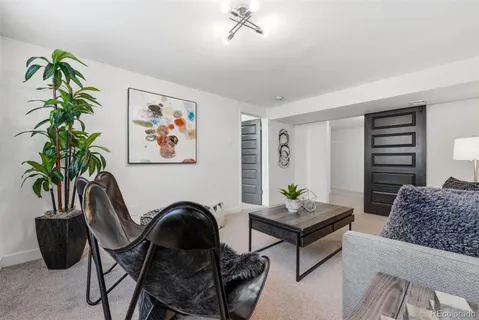 a living room with furniture potted plant and a window