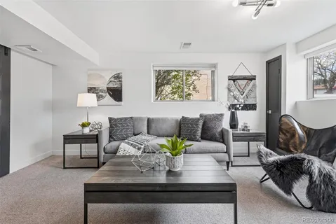 a living room with furniture and painting on the wall